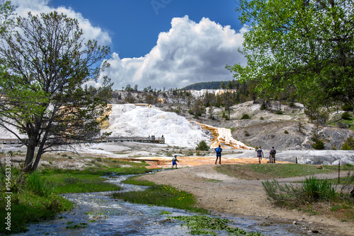 Mineral stream near Mammoth Hot Springs terraces with visitors in Yellowstone National Park