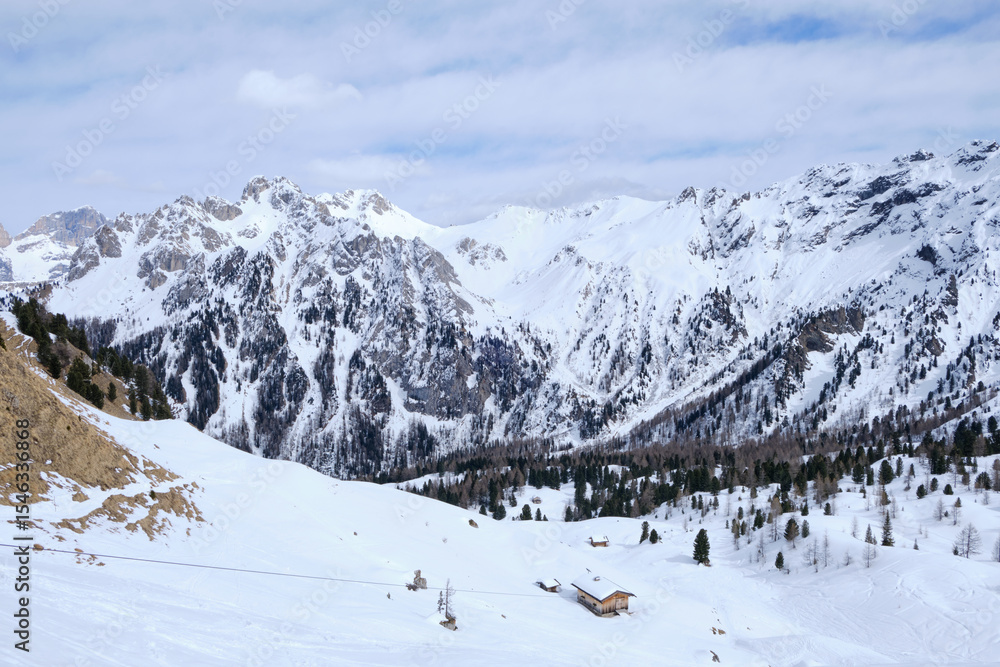 Fototapeta premium March 2025: Scenic view of snow covered mountains against sky, Fassa Valley.