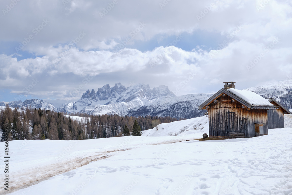 Fototapeta premium March 2025: winter landscape at Ski Area in Dolomites, Italy - Alpe Lusia. Ski resort in val di Fassa near Moena. Winter Dolomites and blue sky. Aerial view on ski slopes