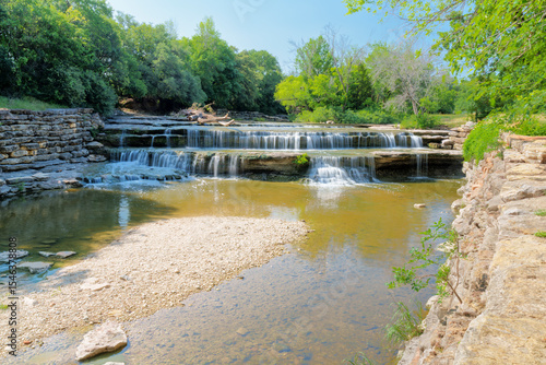 A large fallen tree is snagged at Airfield Falls along the Trinity Trails in west Fort Worth, Texas USA