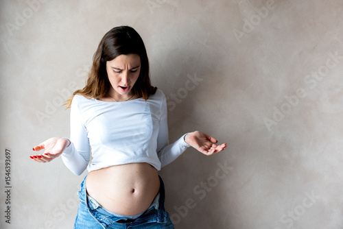 Woman with a bloated belly due to indigestion or pregnancy
