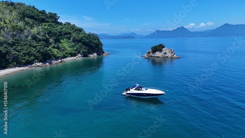 Aerial view of a boat floating in the calm blue waters of the Seto Inland Sea, Japan
