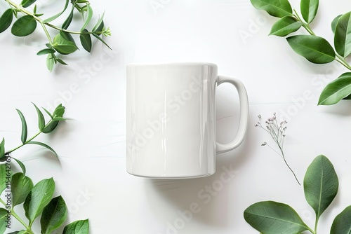 Blank template of white mug and green leaves bouquet on white background  Flat lay, top view