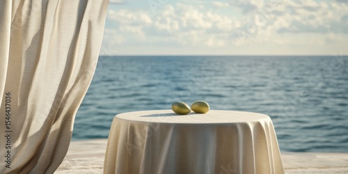 A serene coastal scene featuring a simple table adorned with a tablecloth and two limes, set against a tranquil ocean backdrop. Perfect for hospitality and lifestyle themes.