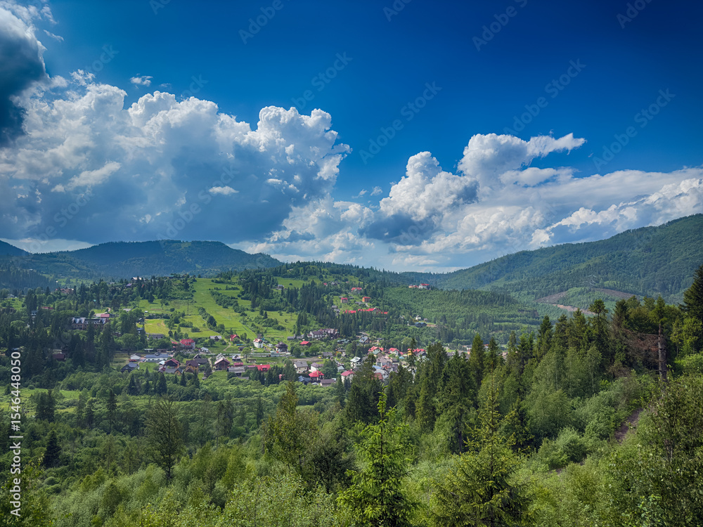 Fototapeta premium Scenic View of the Carpathian Mountains Covered by Clouds on a Sunny Day