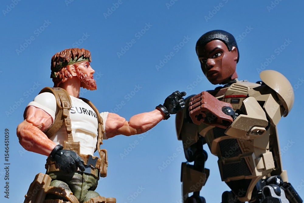 Naklejka premium LEGO Star Wars action figure of ex stormtrooper Finn doing fist bump with GI JOE action figure of Outback, survival instructor, Classified edition 2023. Blue skies background. 