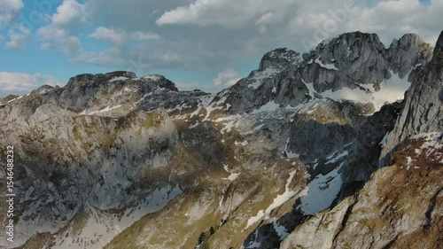 Aerial view of amazing rocky mountains in snow before sunset, Prokletie, Montenegro, 4k