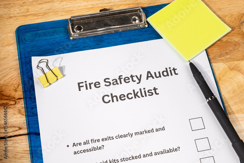 Fire Safety Audit Checklist Paper on Wooden Desk with Pen – Workplace Safety Inspection Concept