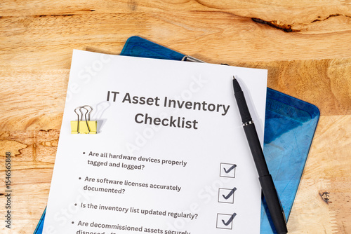 IT Asset Inventory Checklist with Pen on Desk – Technology Management and Audit Concept