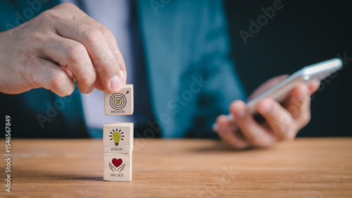 Defining corporate identity: Person assembling blocks depicting mission statement, future vision, and fundamental values, crucial for business success and brand integrity.