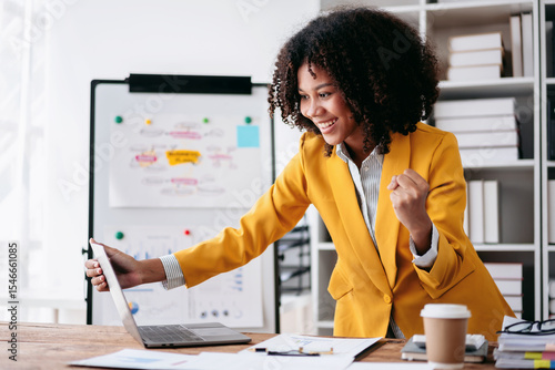 Young Businesswoman Celebrating Success on Laptop in Office Achieving Goals Professional Working Happy Excited For Business Result