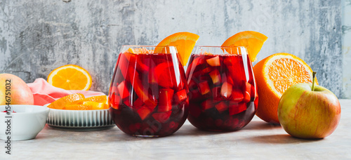 Photos Refreshing summer sangria cocktail with fruits and berries in glasses on the tab