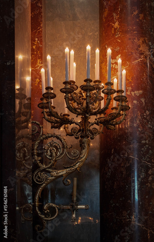 Canvas-taulu Candlelit brass chandelier with golden ornaments in historic European church interior