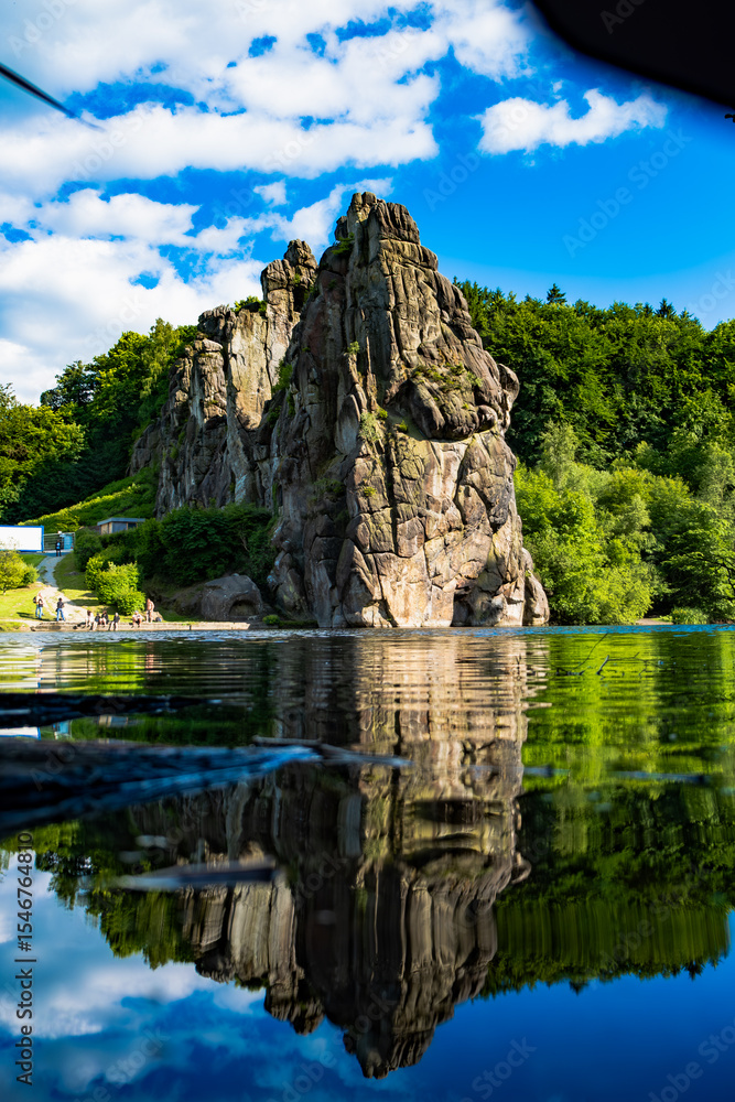 Fototapeta premium Vertical Reflection of Externsteine in Calm Lake, Germany