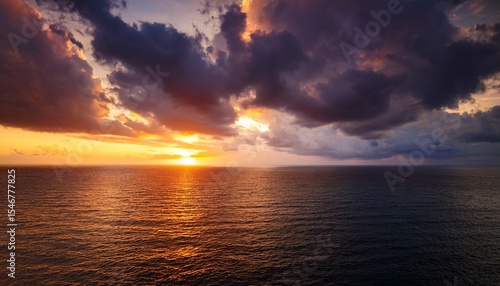 moody sunset sky over the ocean dark clouds illuminated with warm light create a captivating and atmospheric scene