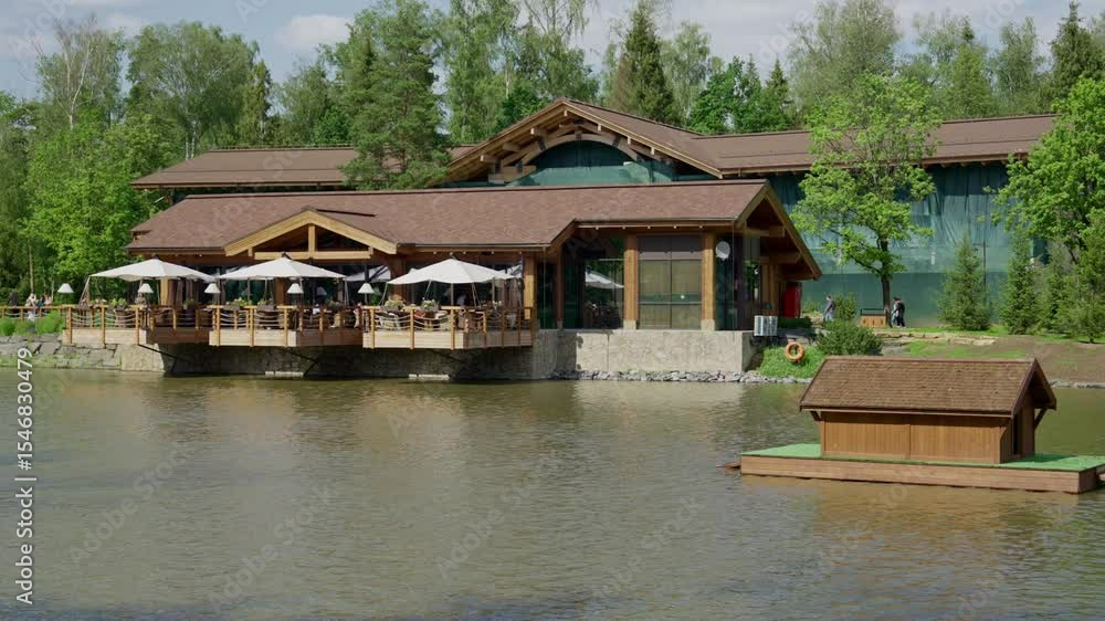 lakeside wooden restaurant terrace with white parasols lakeside wooden restaurant terrace with white parasols