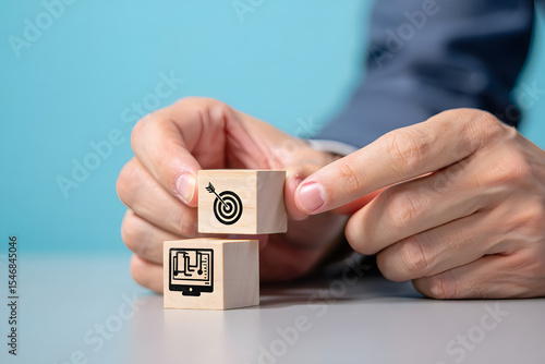 Strategic Planning with Wooden Blocks A Person Arranges Blocks with Target and Data Icons, Symbolizing Business Goals, Analytics, and Technological Solutions