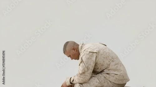 young soldier tearing his dog tag surrounded by gray light showcasing his internal conflict
