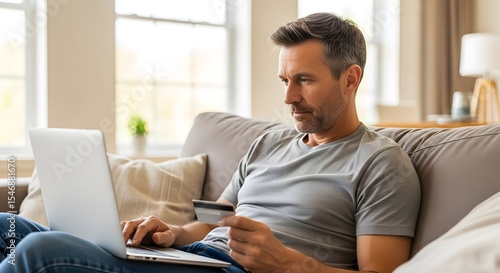 Man working in the morning in the living room with notebook and drinking coffee