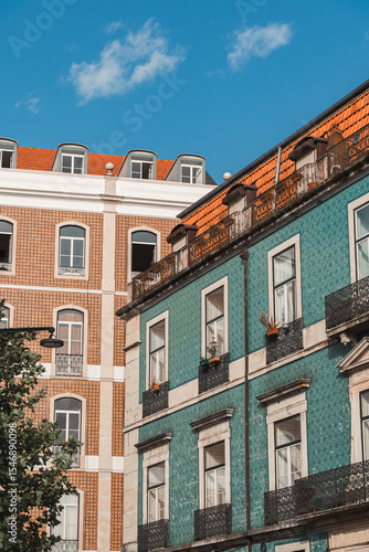 Vibrant Lisbon buildings with iconic azulejo tiles and red rooftops under a clear blue sky, perfect for travel blogs, architecture features, and Portugal tourism content.