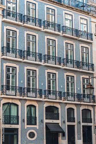 Elegant Lisbon architecture featuring blue azulejo tiles, classic iron balconies, and tall windows. Perfect for travel, culture, and European cityscape design inspiration.