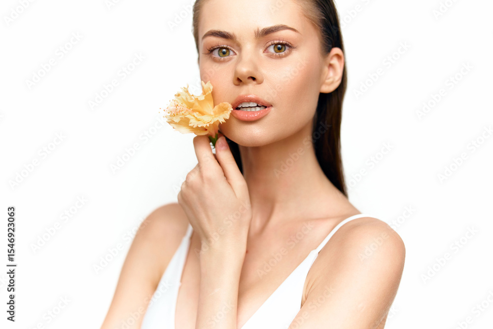 Beautiful model with a flower, showcasing natural beauty and elegance in minimalistic style, perfect for beauty and fashion concepts. Beautiful model with a flower, showcasing natural beauty and elegance in minimalistic style, perfect for beauty and fashion concepts.