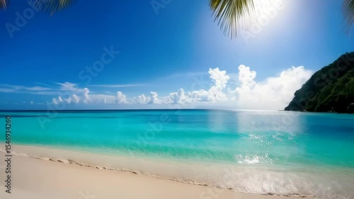 Scenic tropical beach with white sand, turquoise water, and palm trees against blue sky in a sunny summer day for a relaxing vacation