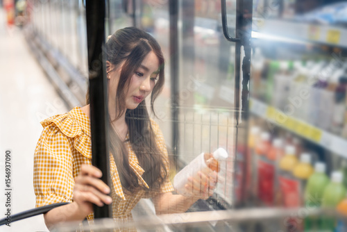 Portrait of beauty asian happy woman relax and enjoy shopping time with trolley cart buy healthy food fresh dairy product of milk and cheese in commercial refrigerators at shopping supermarket Free Download Portrait of beauty asian happy woman relax and enjoy shopping time with trolley cart buy healthy food fresh dairy product of milk and cheese in commercial refrigerators at shopping supermarket - GFXLoad