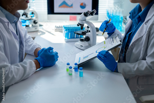 Scientists discussing research results in laboratory setting