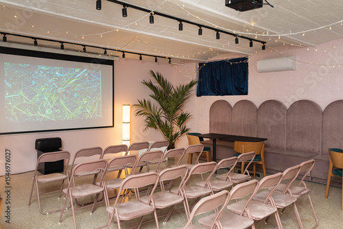 Cozy conference room setup with projector and chairs.