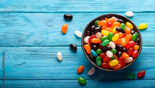 halloween sweets jelly beans in bowl on blue wooden background
