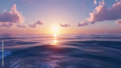 Serene sunset over calm ocean waves, with soft clouds reflecting warm colors in the sky