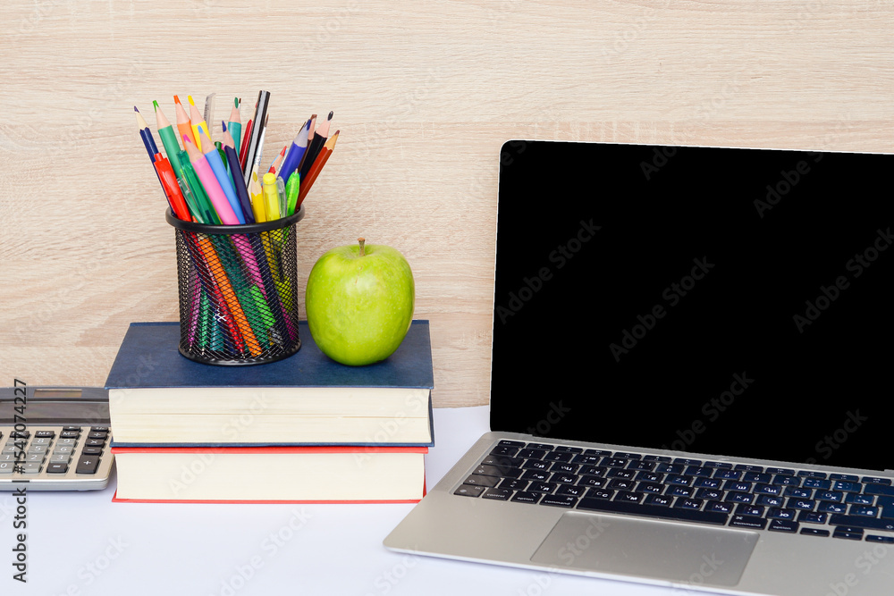 Naklejka premium A Modern Study Workspace Featuring a Laptop, Various Books, and Creative Supply Items