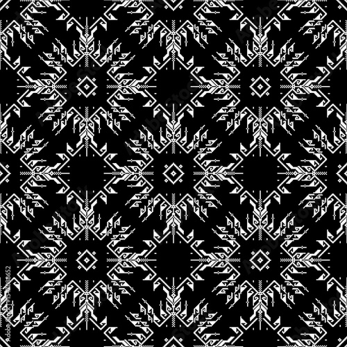 Cross-stitch seamless pattern with tribal motifs in black and white colors. Ukrainian traditional embroidery. Boho style. Pixel art, vyshyvanka, textiles, and wallpaper.