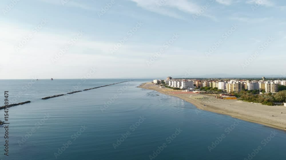Drone view of italian sandy beaches with umbrellas and gazebos.Summer vacation concept.Lido Adriano town,Adriatic coast, Emilia Romagna,Italy. Drone view of italian sandy beaches with umbrellas and gazebos.Summer vacation concept.Lido Adriano town,Adriatic coast, Emilia Romagna,Italy.