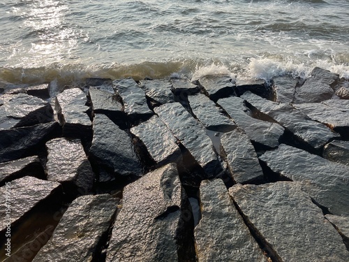 Interlocking Stones Against the Sea
