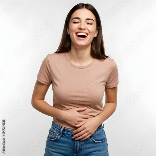 Young woman laughing hard with hands holding stomach, joyful and expressive.
