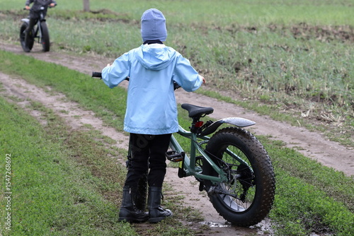 Boy riding a fatbike on a dirt road