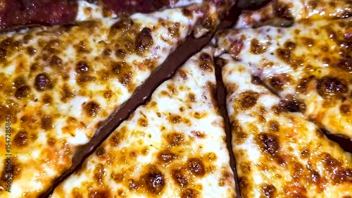 Delicious pizza featuring a combination of cheese and meat lovers toppings, served on a wooden board. The golden cheese stuffed crust