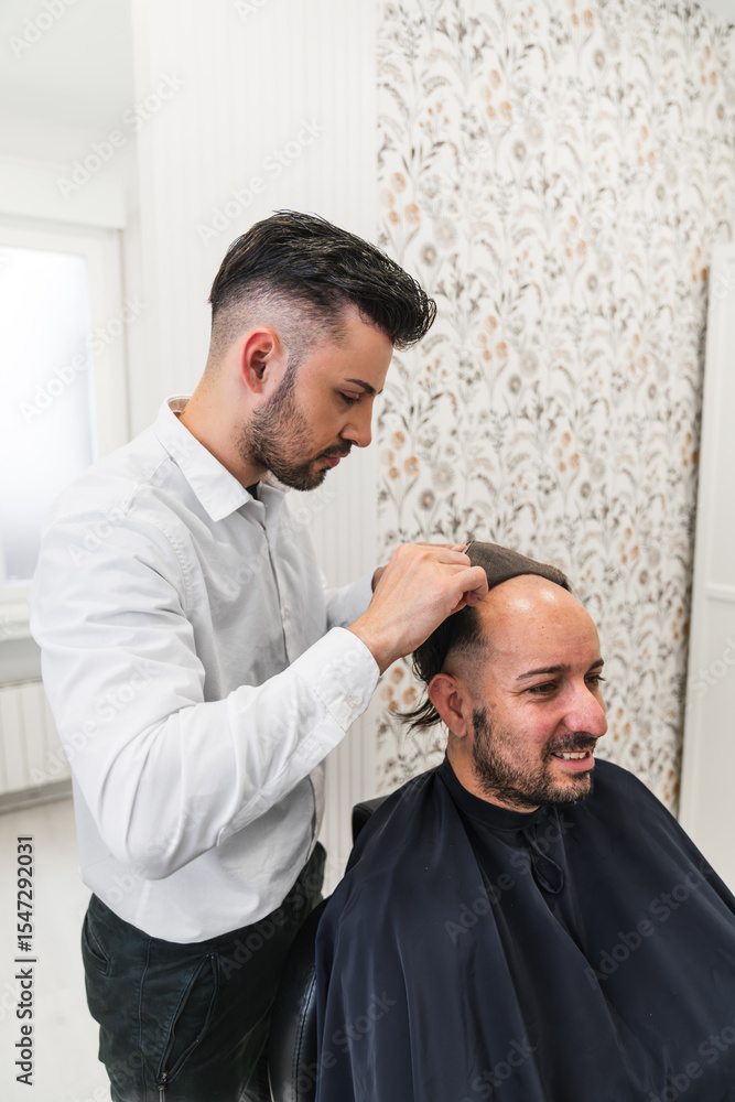 Fototapeta premium Hair specialist carefully placing a hair prosthesis system on smiling patient, offering a non surgical solution for hair loss