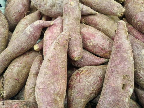 Organic raw purple sweet potatoes from local farmer market in basket. Sweet Potato (Ipomoea batatas), ubi, purple yam good source of antioxidants, particularly anthocyanins, which are linked to variou