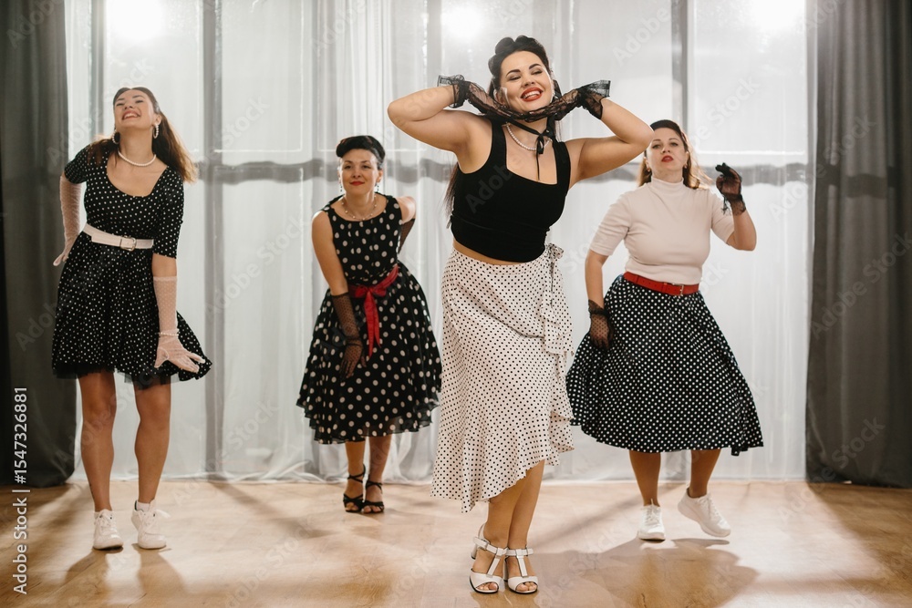 Naklejka premium Pinup dancers wearing polka dots performing rock and roll moves