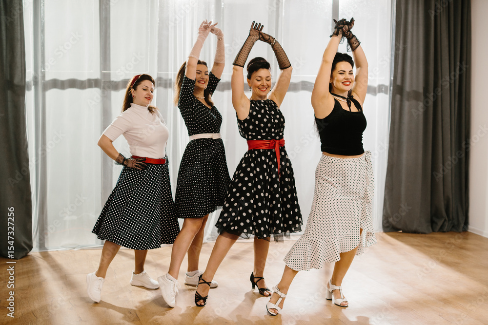 Naklejka premium Four women dancing rock and roll wearing polka dots dresses and skirts