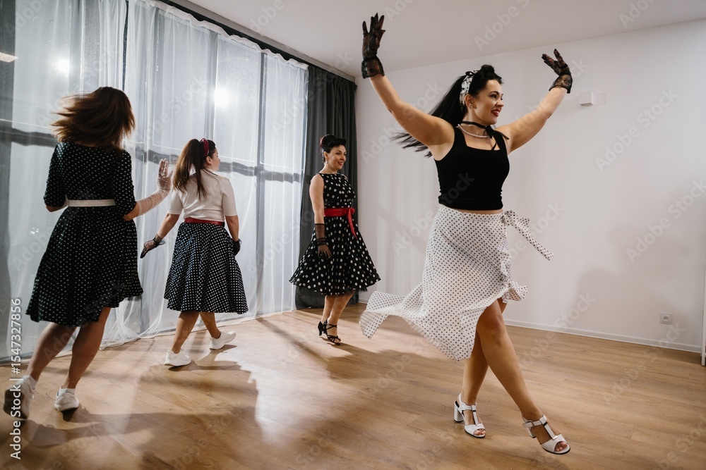 Naklejka premium Women wearing polka dot dresses dancing 1950s style swing dance