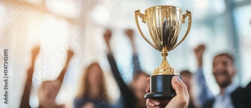 Team celebrating success with trophy in office, motivated employees raising hands in victory, corporate achievement, teamwork, professional achievement, workplace morale.