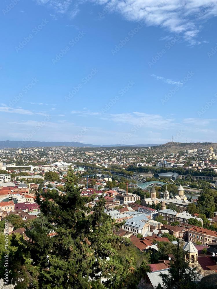 Panoramic view of Tbilisi city with old rooftops and the Bridge of Peace in Georgia Panoramic view of Tbilisi city with old rooftops and the Bridge of Peace in Georgia