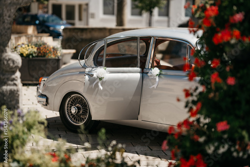 Tableau sur toile Decorated oldtimer wedding car parked near a Bavarian village ready for a romant