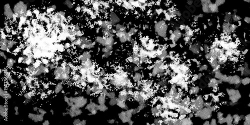 Snowflakes on dark background. white icy snowflakes isolated on black background, natural background. white crystalline powder on a black background. sugar dust. texture, pattern and clipping.