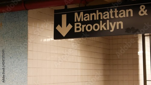 New York subway station interior, Manhattan text sign. Underground metropolitan. United States metro transport navigation. Information signage public passenger railway. Downtown and Brooklyn direction