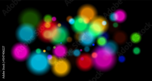Multicolored glowing circles on dark background. Blurred soft shapes of various sizes create abstract festive atmosphere.